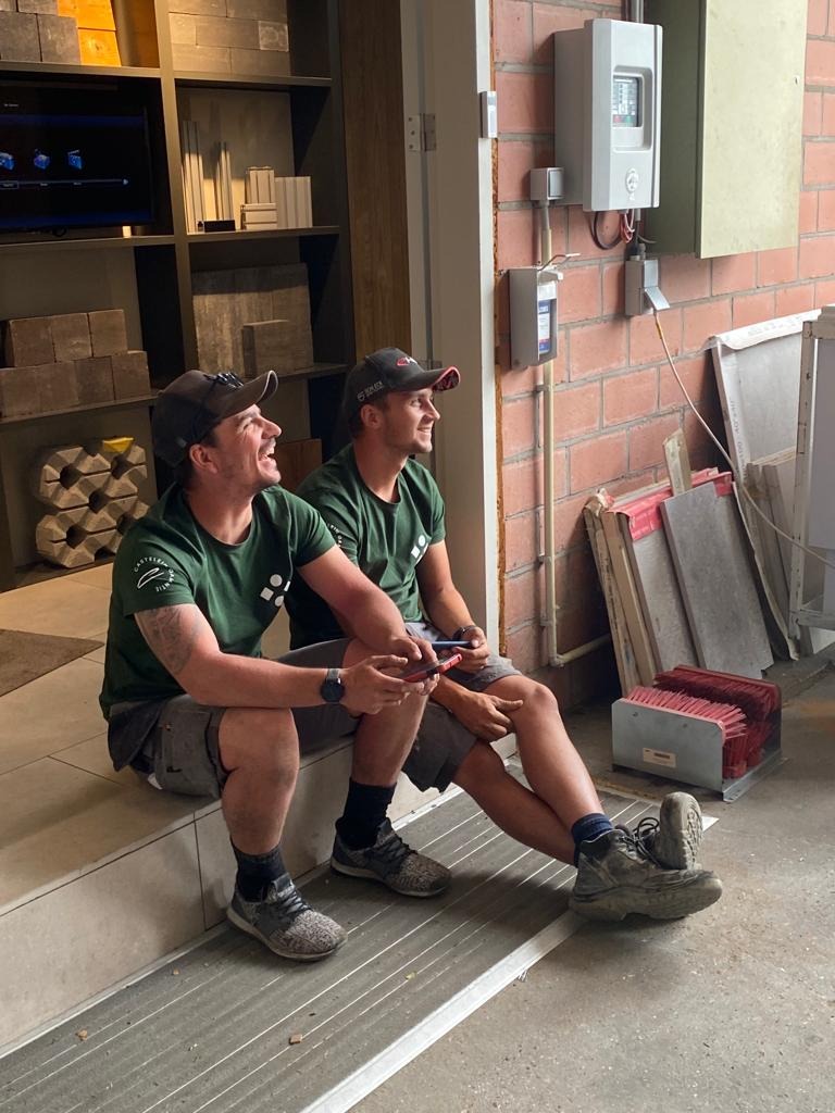 Twee collega’s zitten ontspannen na de lunch tijdens het bouwverlof.
